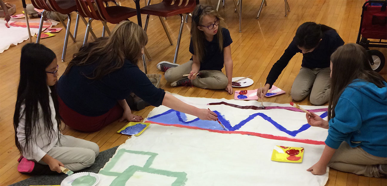 Students painting a classroom mural